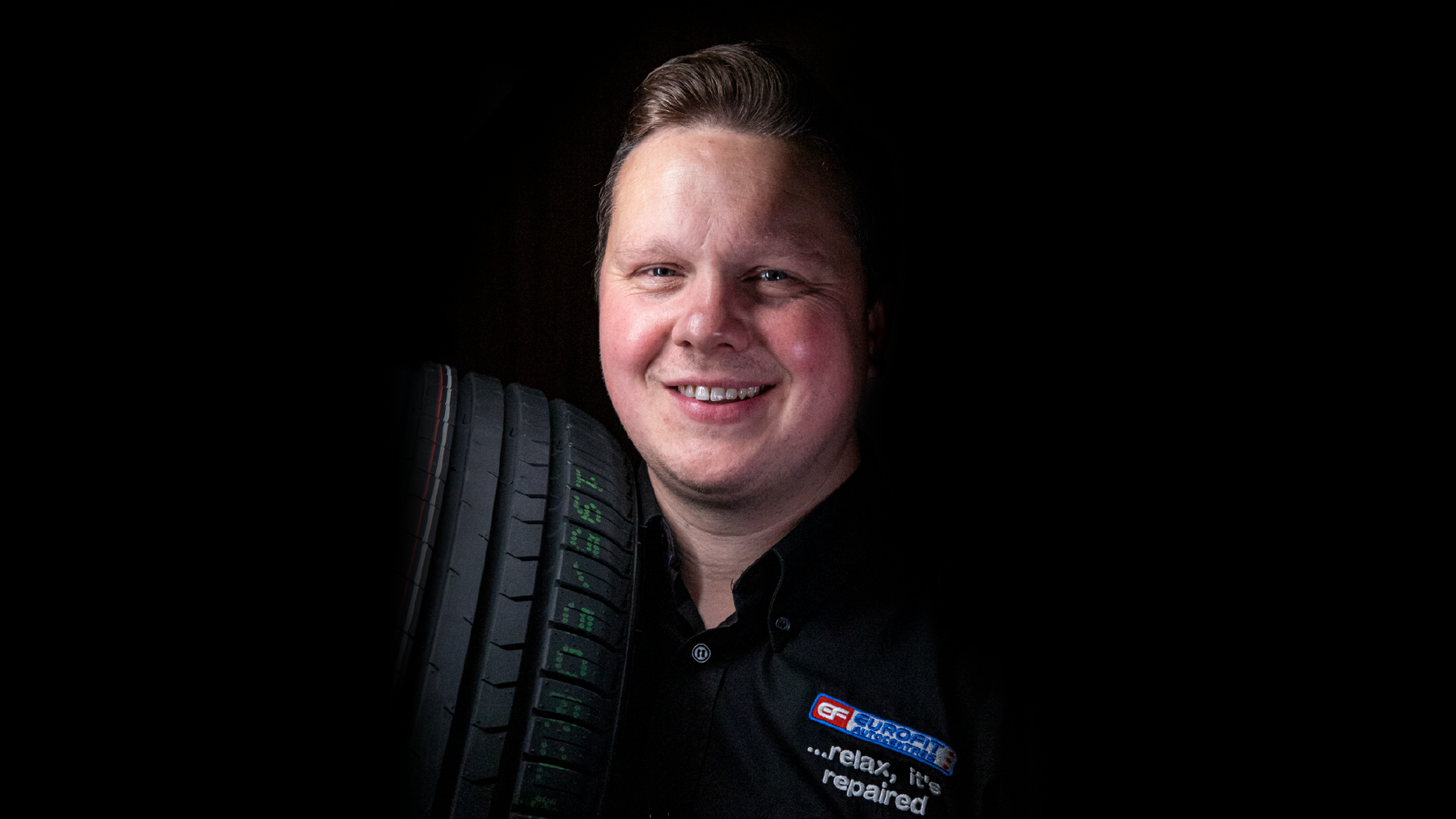 Tyre fitter holding Tyres from Eurofit Autocentres.
